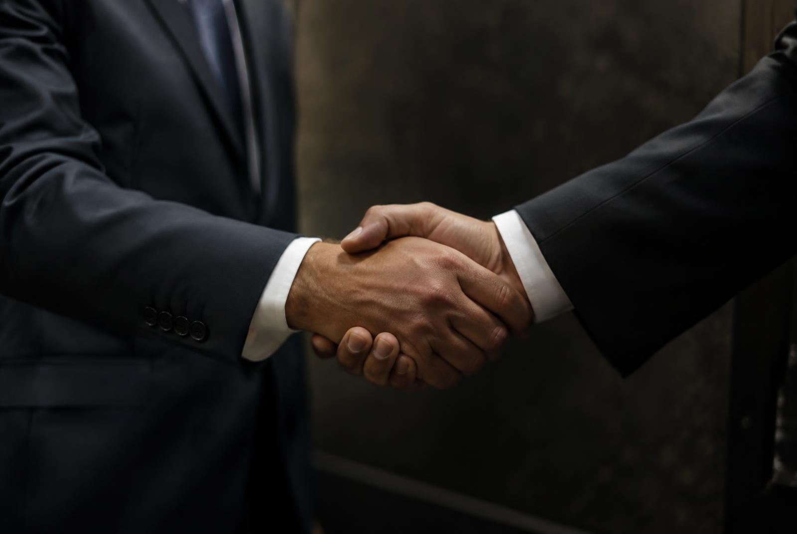 Business handshake closing a supply agreement